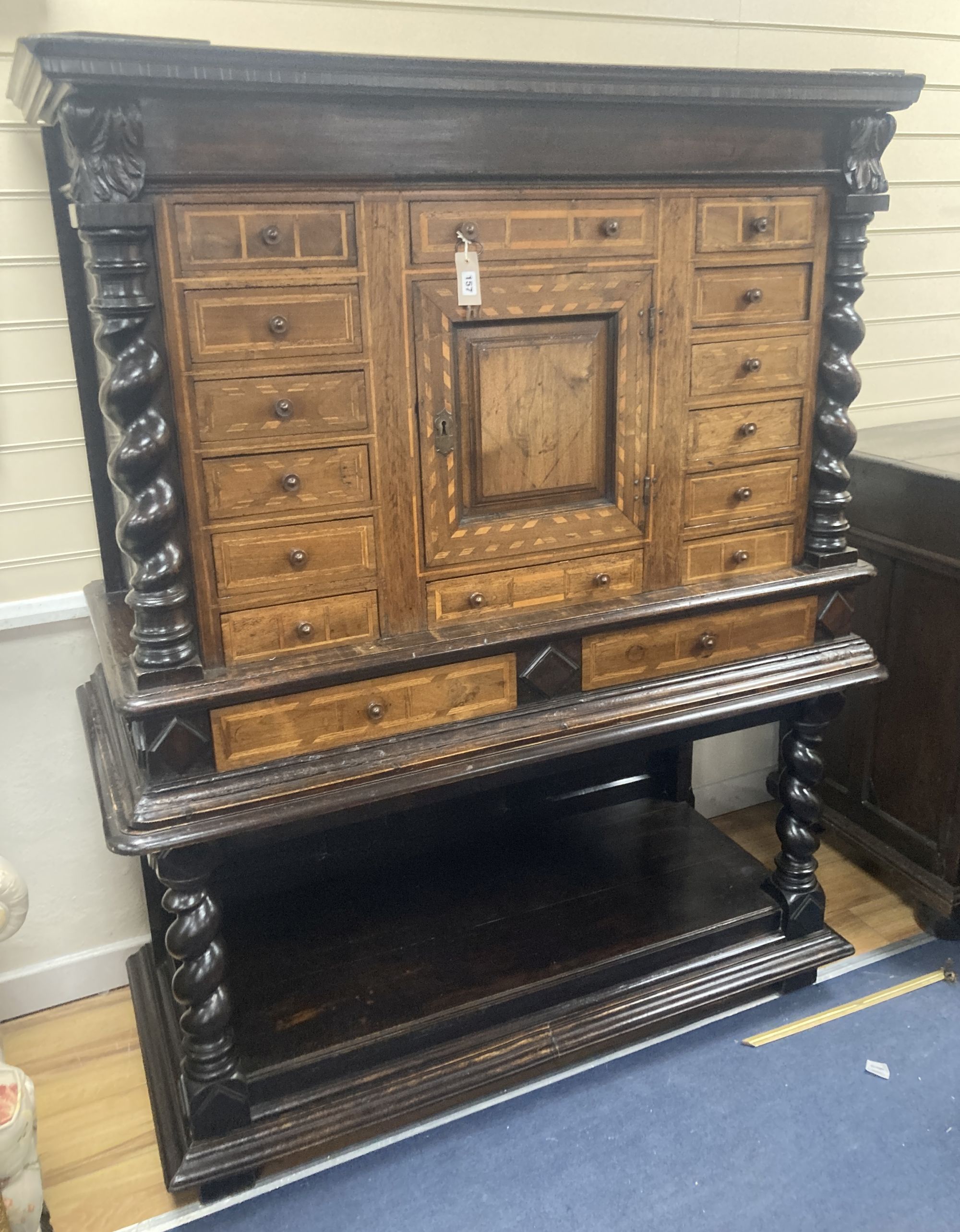 An early 19th century Dutch ebonised parquetry inlaid walnut cabinet on stand, width 136cm, depth 60cm, height 171cm